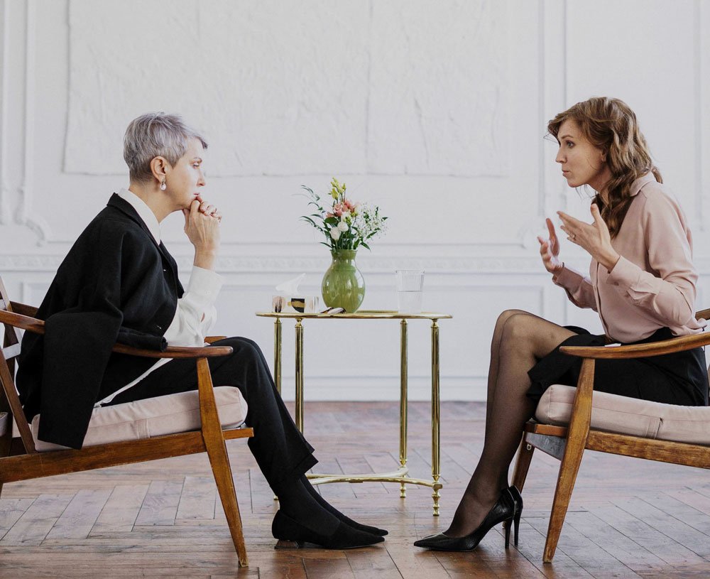 Therapist and client discussing in a therapy session